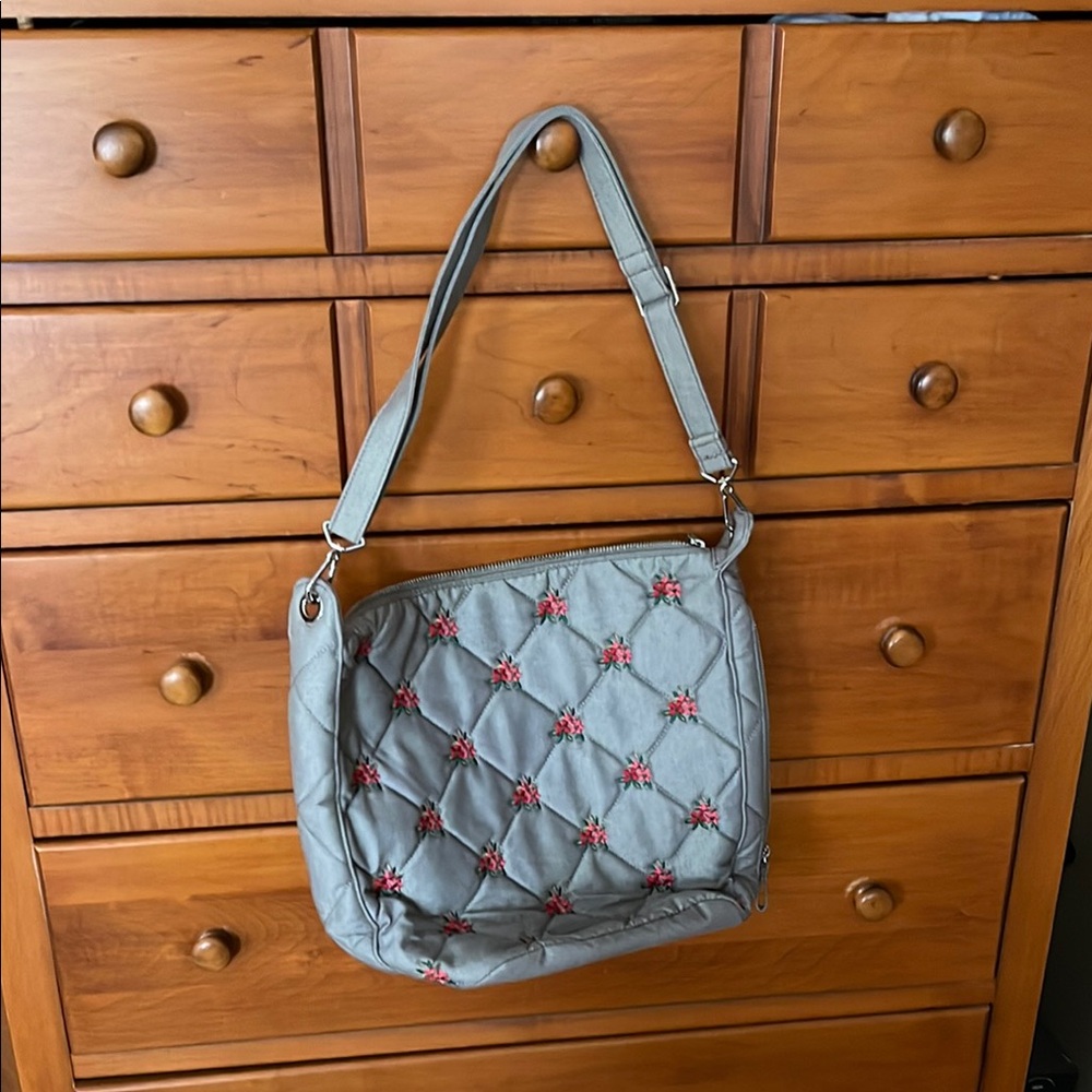 Vera  Bradley handbag in gray with embroidered red/pink flowers.